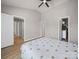 Bright main bedroom with wood plank floors, neutral paint, ceiling fan, and closet at 8516 Paw Valley Ln, Charlotte, NC 28214