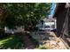 Beautiful backyard featuring a deck, shed, lush lawn, and a serene fire pit area at 9410 Culcairn Rd, Huntersville, NC 28078