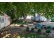 Serene backyard with a shed, deck, mature landscaping, and connecting walkways at 9410 Culcairn Rd, Huntersville, NC 28078
