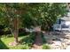 Beautiful backyard featuring a fire pit, a shed, and a pond at 9410 Culcairn Rd, Huntersville, NC 28078