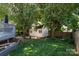 Backyard view with a shed, lawn, and mature trees, enhancing outdoor living at 9410 Culcairn Rd, Huntersville, NC 28078