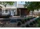 Manicured backyard with a fire pit, screened in porch, and mature landscaping at 9410 Culcairn Rd, Huntersville, NC 28078