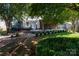 Beautiful backyard featuring a deck, brick path, and lush landscaping at 9410 Culcairn Rd, Huntersville, NC 28078
