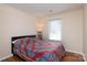 Inviting bedroom with laminate floors and a patterned quilt at 9410 Culcairn Rd, Huntersville, NC 28078