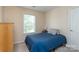 Serene bedroom featuring a bright window and soft blue bedding at 9410 Culcairn Rd, Huntersville, NC 28078