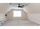 Spacious bonus room with neutral carpet, a large window, and wall-mounted TV at 9410 Culcairn Rd, Huntersville, NC 28078