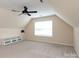Large bonus room with neutral carpet and a window at 9410 Culcairn Rd, Huntersville, NC 28078