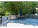 Spacious deck with outdoor seating, sheltered by mature trees at 9410 Culcairn Rd, Huntersville, NC 28078