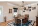 Comfortable dining room featuring a wooden table, area rug, and elegant lighting at 9410 Culcairn Rd, Huntersville, NC 28078