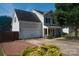 The house features an attached garage, brick-paved driveway, and a side-angled view of the home's exterior at 9410 Culcairn Rd, Huntersville, NC 28078