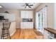 Bright kitchen area featuring white cabinetry, hardwood floors and a ceiling fan at 9410 Culcairn Rd, Huntersville, NC 28078