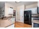 Charming kitchen featuring modern black appliances, countertops and white cabinetry at 9410 Culcairn Rd, Huntersville, NC 28078