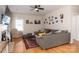 A cozy living room showcasing hardwood floors, a ceiling fan, a fireplace, and a comfortable gray sectional at 9410 Culcairn Rd, Huntersville, NC 28078