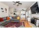 The open-concept living room flows seamlessly into the kitchen with views of the fireplace and comfortable sectional at 9410 Culcairn Rd, Huntersville, NC 28078
