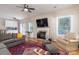 The living room includes a fireplace, hardwood floors, a ceiling fan, and views leading into the dining area at 9410 Culcairn Rd, Huntersville, NC 28078