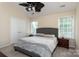 Bright main bedroom with ceiling fan, a gray bed and large windows at 9410 Culcairn Rd, Huntersville, NC 28078
