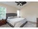 Comfortable main bedroom with ceiling fan, large windows and gray bedding at 9410 Culcairn Rd, Huntersville, NC 28078