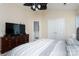 Spacious main bedroom featuring a gray bed and a TV on dark wood dresser at 9410 Culcairn Rd, Huntersville, NC 28078