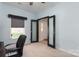 A home office with blue walls, neutral carpet, and a black leather desk chair at 9410 Culcairn Rd, Huntersville, NC 28078