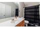 Neutral bathroom features wooden vanity and framed mirror at 9530 Drains Bay Ct, Charlotte, NC 28214