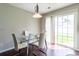 Bright dining area with a glass table, seating for four, and natural light from sliding door at 9530 Drains Bay Ct, Charlotte, NC 28214