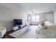 Inviting living room with a large TV, contemporary furniture, and neutral decor at 9530 Drains Bay Ct, Charlotte, NC 28214
