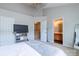 Bright main bedroom boasts neutral tones and doorway to ensuite at 9530 Drains Bay Ct, Charlotte, NC 28214