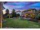 Spacious backyard featuring a fire pit, seating, and lush landscaping with a view of the house at 1026 Arges River Dr, Fort Mill, SC 29715