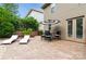 Outdoor patio featuring lounge seating, an umbrella-covered table, and double french doors into the home at 1026 Arges River Dr, Fort Mill, SC 29715