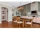Dining room with hardwood floors, a modern light fixture, and a dining table for four at 1026 Arges River Dr, Fort Mill, SC 29715