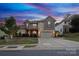 Attractive two-story home with brick facade, well-kept lawn, and a two-car attached garage at 1026 Arges River Dr, Fort Mill, SC 29715