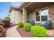 Cozy front porch featuring stone columns, two chairs, and well-maintained landscaping at 1026 Arges River Dr, Fort Mill, SC 29715