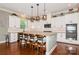 Well-equipped kitchen with granite countertops, white cabinetry, stainless appliances, and bar stool seating at 1026 Arges River Dr, Fort Mill, SC 29715