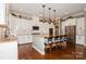 Modern kitchen with white cabinets, granite countertops, stainless steel appliances, and a large center island at 1026 Arges River Dr, Fort Mill, SC 29715