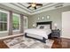 Relaxing main bedroom with tray ceilings, a ceiling fan and bright windows at 1026 Arges River Dr, Fort Mill, SC 29715