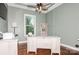 Bright home office with a wooden desk, light green walls and hardwood flooring at 1026 Arges River Dr, Fort Mill, SC 29715