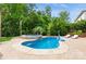 Beautiful backyard pool and hot tub with lush landscaping and lounge chairs, perfect for outdoor relaxation at 1026 Arges River Dr, Fort Mill, SC 29715
