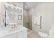 Bright bathroom featuring a glass shower, vanity with double sinks and gold hardware, with neutral finishes at 106 N Laurel Ave # 118, Charlotte, NC 28207