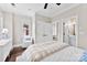 Comfortable bedroom with white trim, a plush chair, and access to a bathroom and closet at 106 N Laurel Ave # 118, Charlotte, NC 28207