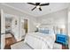 Bright bedroom featuring ensuite bath, ceiling fan and beautiful natural light from large windows at 106 N Laurel Ave # 118, Charlotte, NC 28207