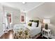 Bright bedroom with hardwood floors, two windows bringing in natural light, and neutral wall colors at 106 N Laurel Ave # 118, Charlotte, NC 28207