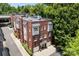Beautiful exterior view of a brick townhouse with attached garages and manicured landscaping at 106 N Laurel Ave # 118, Charlotte, NC 28207