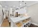 Bright and airy kitchen with white cabinetry, granite counters and stylish pendant lights at 106 N Laurel Ave # 118, Charlotte, NC 28207