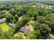 An aerial view displays the home's location within a community surrounded by mature trees at 108 Woodwinds St, Locust, NC 28097