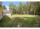 Expansive backyard with lush green grass and mature trees at 108 Woodwinds St, Locust, NC 28097