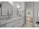 Bright bathroom featuring double sinks with stone countertops and white cabinetry at 108 Woodwinds St, Locust, NC 28097