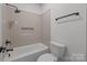 Bathroom with shower/tub combination and tiled walls and matte black fixtures at 108 Woodwinds St, Locust, NC 28097