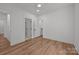 Bright bedroom with wood-look floors and white trim plus doorways to closet and bathroom at 108 Woodwinds St, Locust, NC 28097