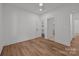 Bright bedroom with wood-look floors, closet, and trim plus access to ensuite bathroom at 108 Woodwinds St, Locust, NC 28097