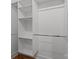 Close-up of a white walk-in closet with shelves and rods for clothing storage at 108 Woodwinds St, Locust, NC 28097